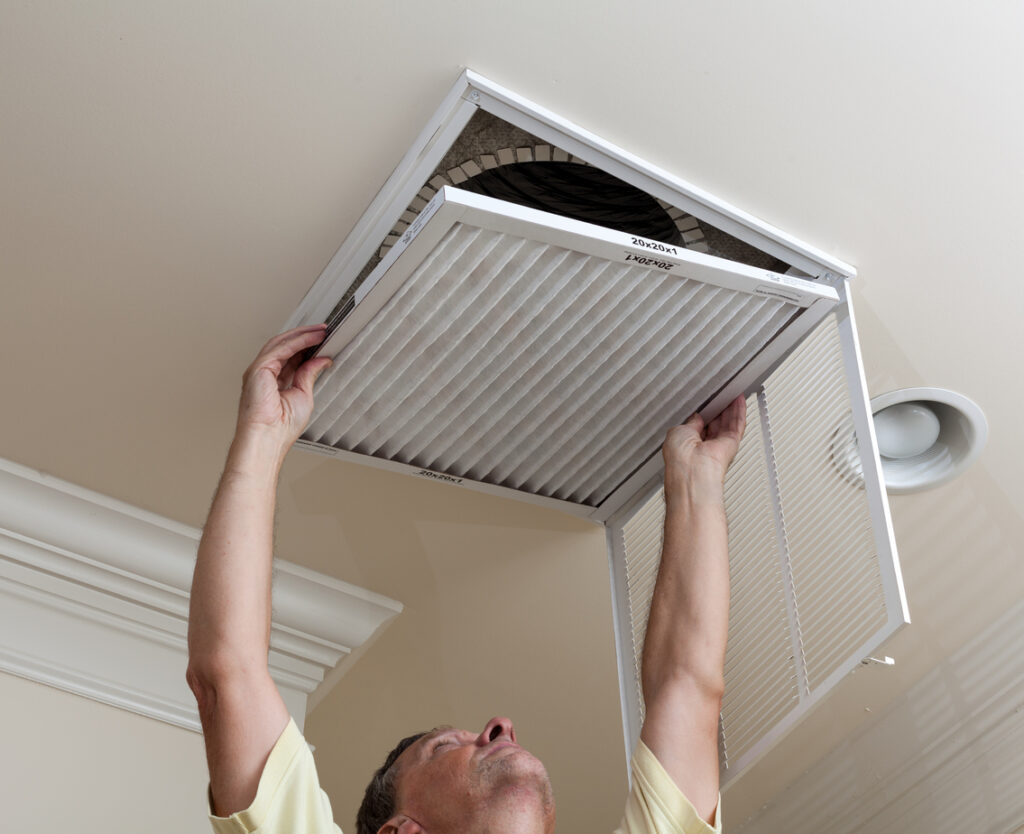 HVAC technicians changing AC filter