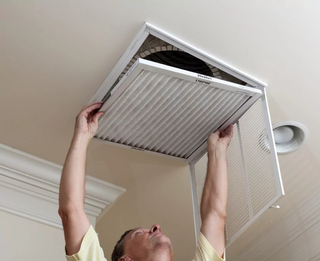 HVAC technicians changing AC filter