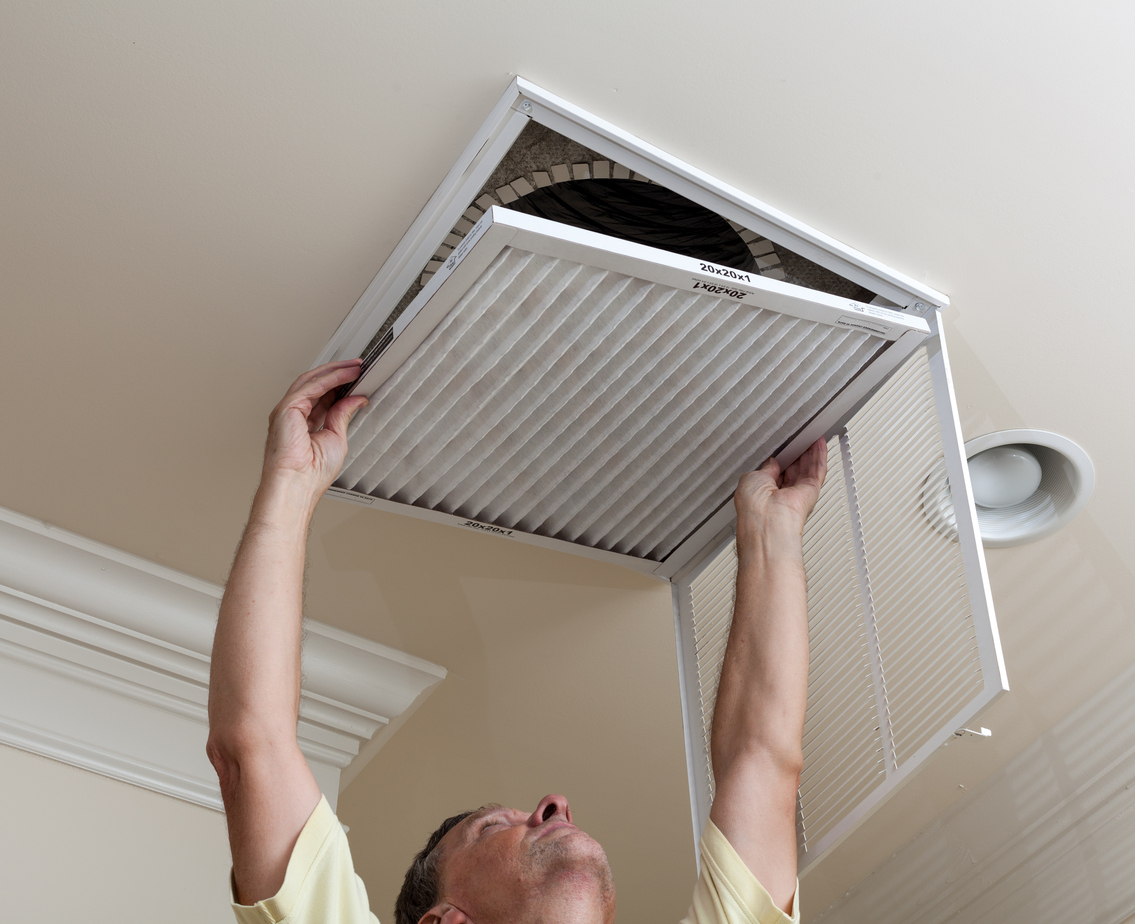 HVAC technicians changing AC filter 